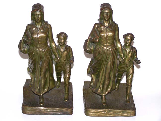 A fine and rare pair of Antique Bookends circa 1930 depicting a Pioneer Woman and Her Son